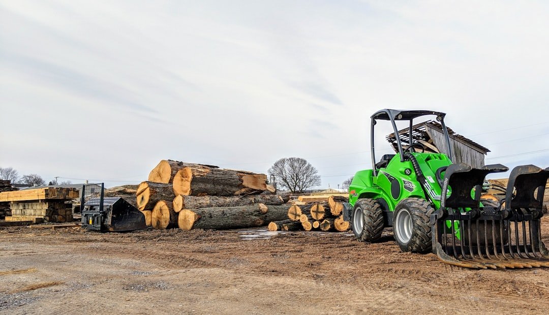 Avant Tecno Wheel Loader model 755 in use on a lumber mill sight using a commercial grapple.